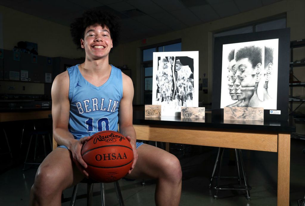 Portrait - HM - Olentangy Berlin senior guard Kaleb Harrell is shown with examples of his artwork at Olentangy Berlin High School in Delaware. (Shane Flanigan / ThisWeek Community News)