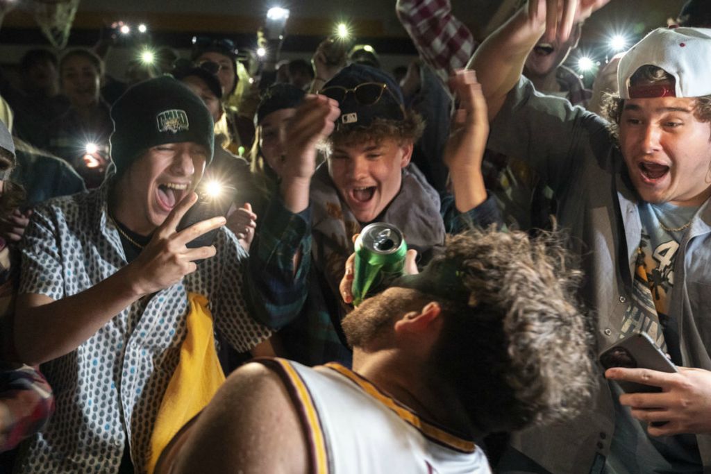 Sports Feature - 3rd place - From left: Zach Caruthers, Tucker Davis and Andrew Dodson cheer on Caleb Burnem while he shotguns a Sprite prior to the Meigs Marauders basketball game with the Wellston Golden Rockets, in Pomeroy. Wellston went on to win 70-54. (Joseph Scheller / WOUB Public Media)