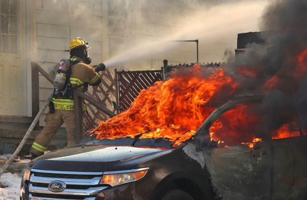 Spot News - 3rd place - The Springfield Fire Division responded to a fully engulfed detached garage fire at 1661 Summit Street. The Fire Division was able to limit any damage to the house, which was just a few feet away, but the garage and it's contents, including a car, was destroyed. (Bill Lackey / Springfield News-Sun)