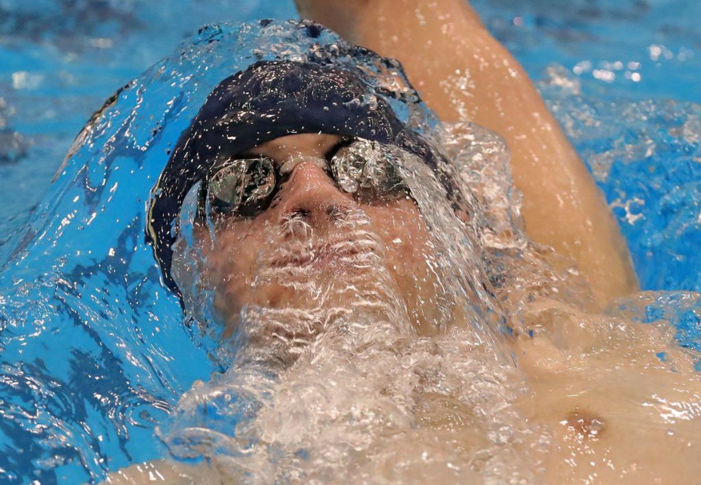 Sports - HM - Hoban’s Parker Smith emerges from the water as he competes in the backstroke leg of the 200 IM event during the Division II district swimming and diving championships, in Cleveland. (Jeff Lange / Akron Beacon Journal)