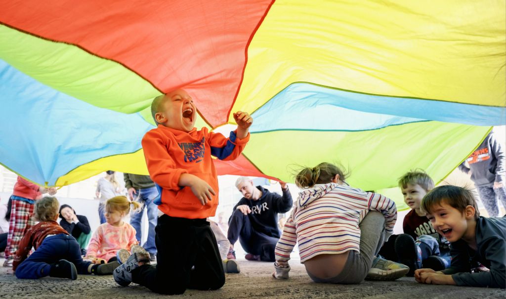 Feature - 1st place - Koda Himes, 2, of Sylvania plays under a parachute during a dance party for kids ages 2-5 at the King Road Library in Sylvania.   (Jeremy Wadsworth / The Blade)