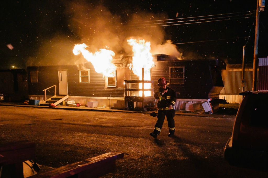 Spot News - 1st place - New Philadelphia Fire Department Captain Steve Wright establishes incident command at the scene of a mobile home fire on 11th Street NW, in New Philadelphia. (Andrew Dolph / The Times Reporter)