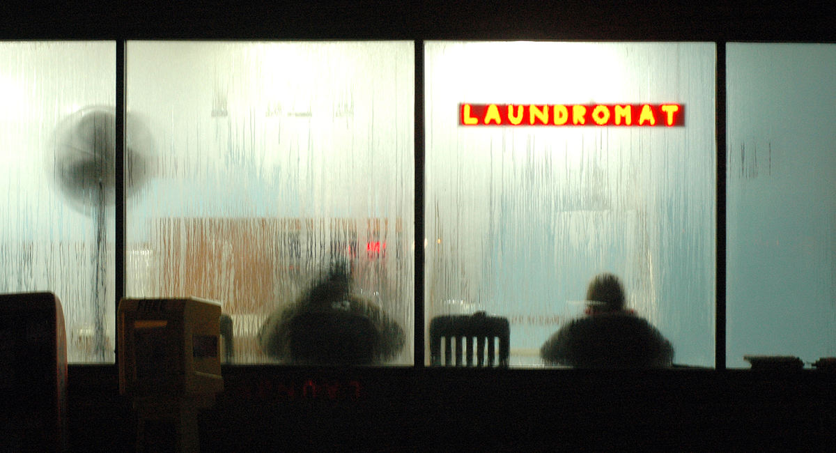 Feature - 1st place - Lloyd and Pat Wilson of Washingtonville read the paper as they wait for their laundry to run through its cycles at the Leetonia Laundromat.  (Patricia Shaeffer / The (Lisbon) Morning Journal)