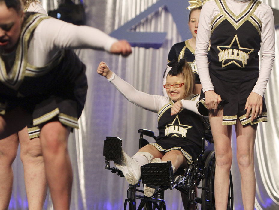 Feature - HM - Cydne Roush of Parkersburg, West Virginia cheers from her wheelchair during the Athletic Championships Cheering contest at the Columbus Convention Center. Roush is a member of the Ohio Valley All Stars Special Needs Twinkles cheering squad. The team practices once a week and participates in a contest once a month.  (Neal C. Lauron / The Columbus Dispatch)