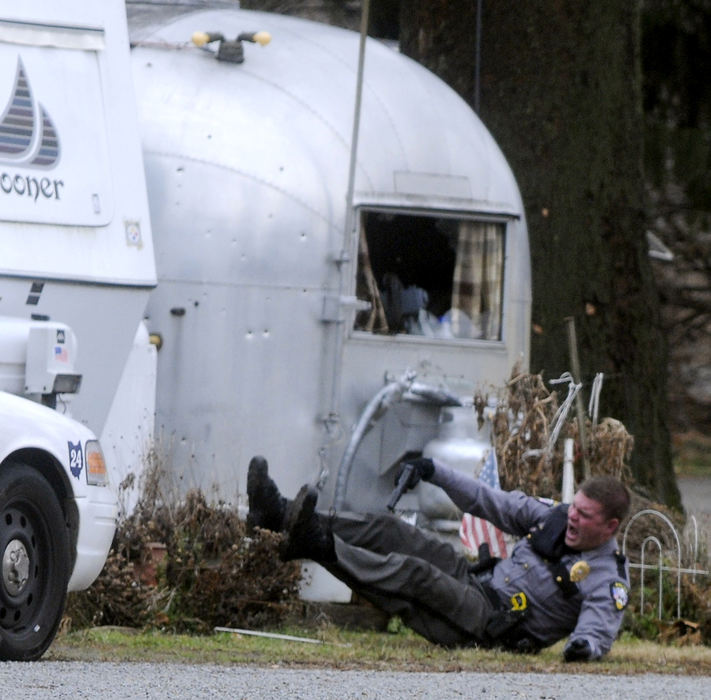 Spot News - 1st place - German Township patrolman Jeremy Blum is wounded in a police shootout with a gunman at Enon Beach trailer park in Mad River Township. Blum was shot in the arm and shoulder, and taken to Miami Valley Hospital. (Marshall Gorby / Springfield News-Sun)