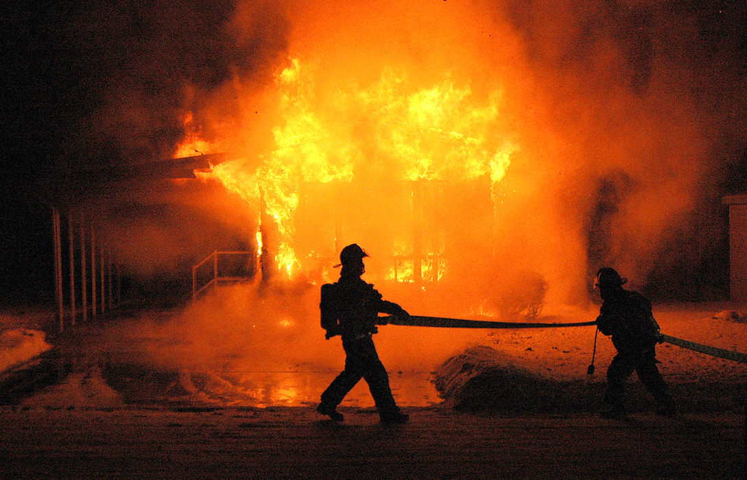 Spot News - 3rd place - Columbiana firefighters drag a hose into position shortly after arriving at a blazing home at the Southern Terrace development on state Route 164.  (Patricia Shaeffer / The (Lisbon) Morning Journal)