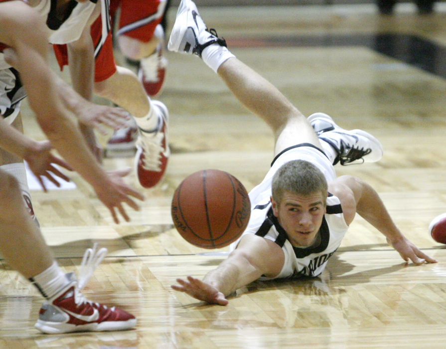 Sports - 3rd place - Carrollton's John Lowdermilk drives after a loose ball in the fourth guarter of their game against Logal Elm at North Canton.  (Scott Heckel / The (Canton) Repository)