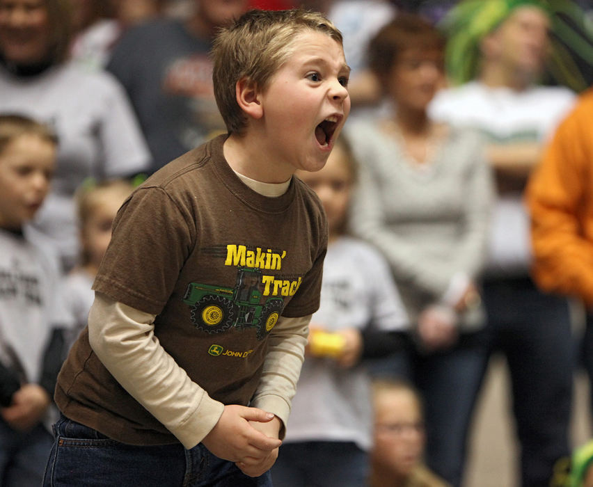 Story - 1st place - Noah Longyear, 6, yells for his cousin Caleb Freed, 4, (not in picture) to keep on pedaling  during the Grand National Championship Finals at the Power Show Ohio in the Coliseum at the Ohio State Fairgrounds in Columbus. (Kyle Robertson / The Columbus Dispatch)