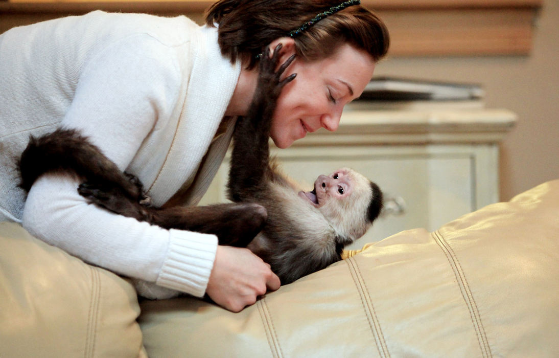 Portrait - 2nd placeCapuchin monkey Nick and Ashley Finley play in owner Shelley Finley's (who is Ashley's mom) Dublin home. (Fred Squillante / The Columbus Dispatch)