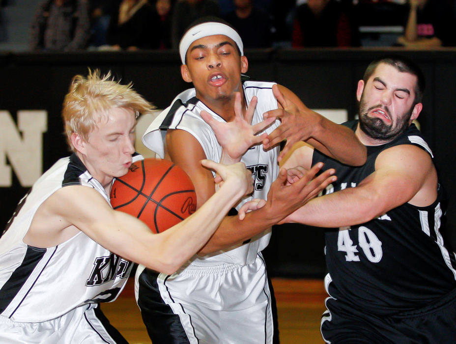 Sports action - 3rd placeTravis Gray (23) and Anthony Colletti (24) of Greenon compete for a rebound with Grant Hall (40) of Graham. (Barbara J. Perenic / Springfield News-Sun)