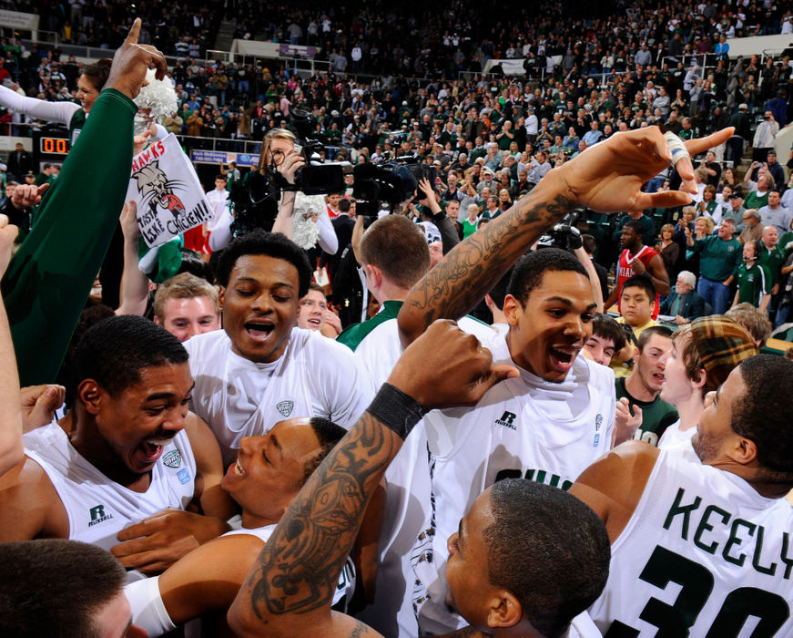 Sports feature - 1st placeThe Bobcats celebrate as students rush the court after their 69-65 win over arch-rival Miami at the Convocation Center in Athens. (Joel Hawksley / Ohio University)