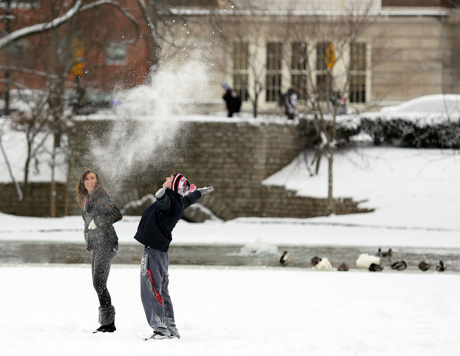 Feature - 3rd placeStanding on a frozen portion of Mirror Lake, freshmen Luke Kollin, of Cleveland, and Emily George, of Cincinnati, spend time with fellow freshmen Jeremy Devine, of Potomac, Md. and David Edwards, of Novi, Mich. (not pictured). The four live in the same dorm, Drackett Tower, at Ohio State and decided to test the stability of the lake after they were finished with their classes for the day.  (Jonathan Quilter / The Columbus Dispatch)