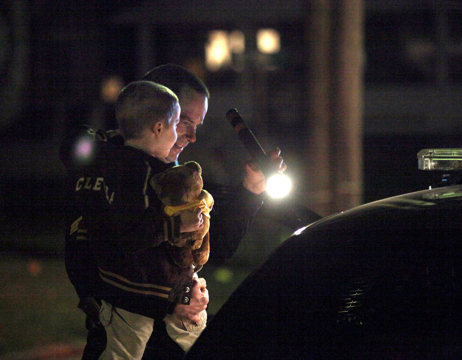 Spot News - 3rd placeAshtabula County Sheriff’s Deputies Sgt. James Kemmerle shows a young boy the inside of a sheriff’s cruiser after Kemmerle completed searching a vehicle for drugs and associated paraphernalia in Ashtabula. (William A. West / Freelance)