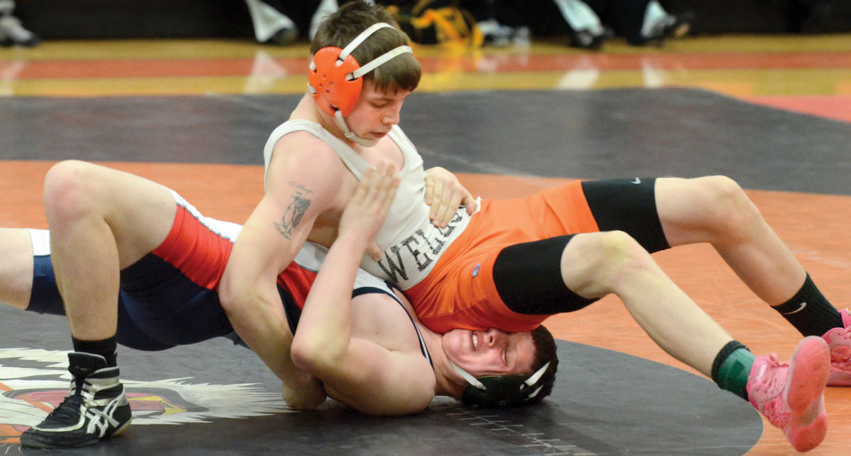 Sports - 3rd placeWellsville's Blake Johnston wrestles West Geauga's alex Stewart in a 152-pound match at the Buck Bailey Memorial Tournament at Wellsville High School. (Patricia Schaeffer / The (Lisbon) Morning Journal)