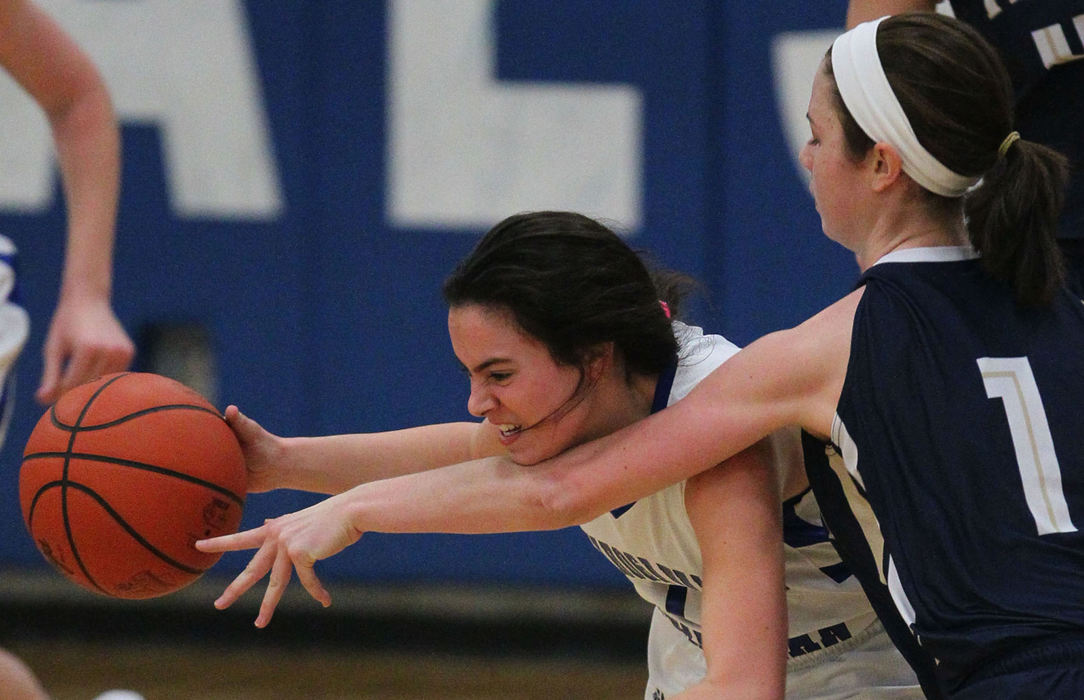 Sports - HMHoban's Allie Griffith (right) clotheslines Cuyahoga Valley Christian Academy's Angelica Owen as she brings the ball down court.  (Michael Chritton / Akron Beacon Journal)