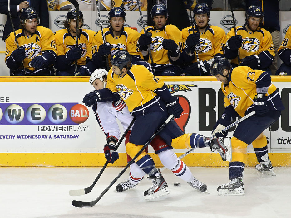 Story - 1st placeColumbus Blue Jackets right wing Jared Boll (40) takes a hit from Nashville Predators right wing Brandon Yip (18) during the 1st period at Bridgestone Arena. (Kyle Robertson / The Columbus Dispatch)