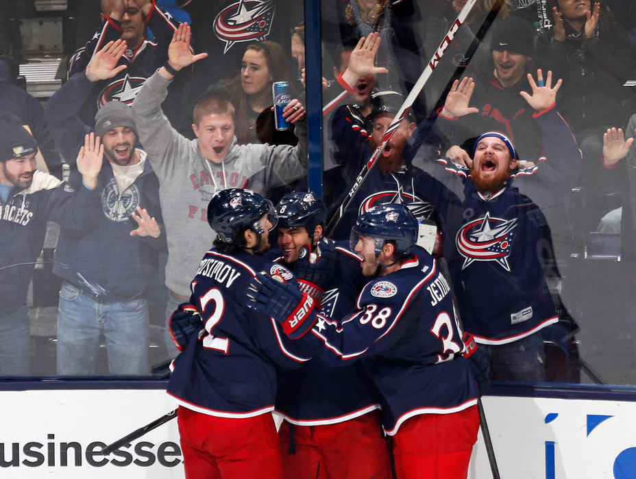 Sports Feature - 2nd place - Fans erupt as Columbus Blue Jackets center Boone Jenner (38) and center Artem Anisimov (42) congratulate right wing Nathan Horton (8) on scoring a goal during second period of their NHL game at Nationwide Arena in Columbus. (Adam Cairns / The Columbus Dispatch)