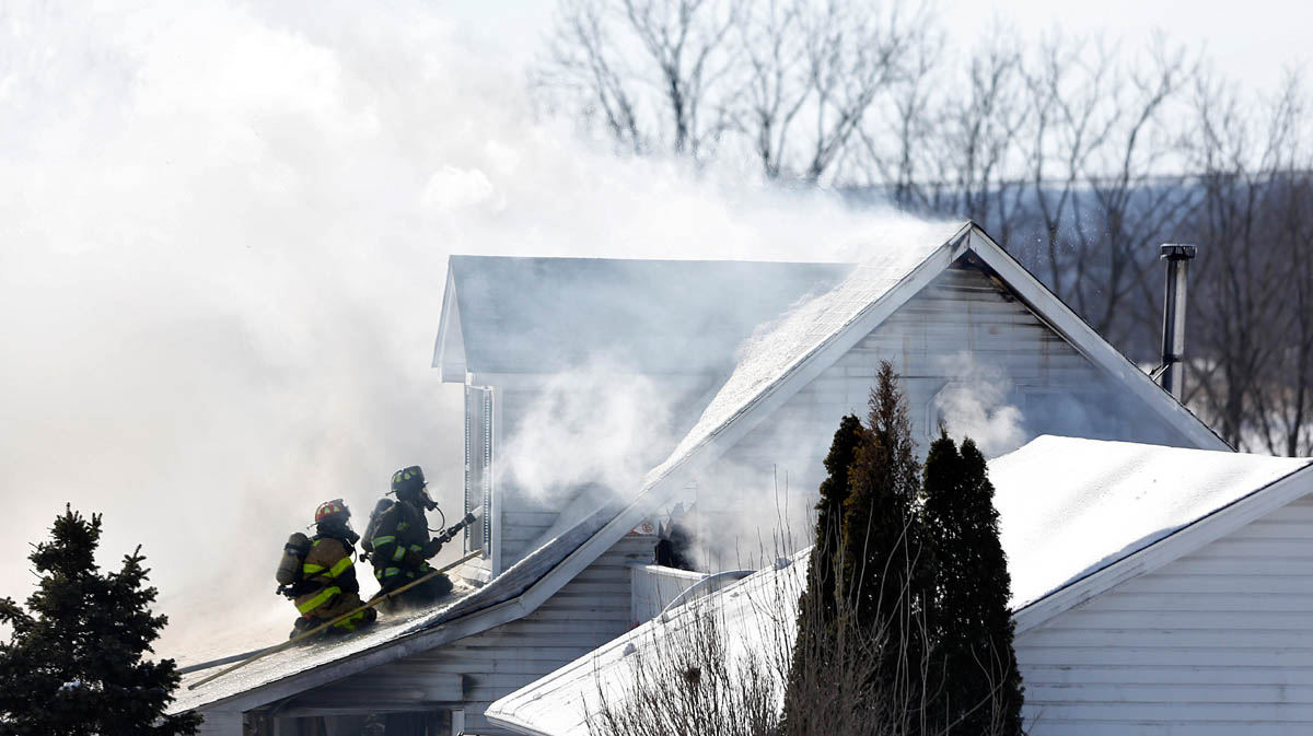 Spot News - 1st place - Firefighters battled flames, below freezing temperatures, smoke and steam as they fought to control a fire at 9808 Shelley Road in Thornville.  A neighbor believed that the fire started in a chicken coop next to the home that was being heated with a space heater.   (Chris Russell / The Columbus Dispatch )