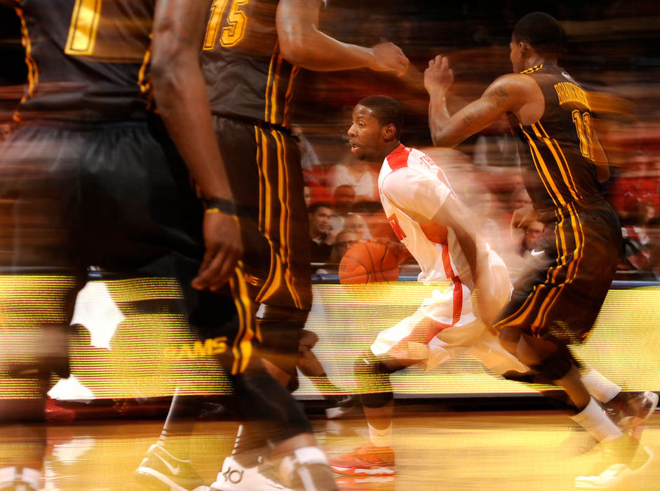 Sports - 1st place - Dayton's Skoochie Smith blurs past the VCU defense during the 2nd half of action at UD Arena. VCU rolled past the Flyers for a 80-66 win. (Erik Schelkun/Elsestar Images / Erik Schelkun/Elsestar Images fo)