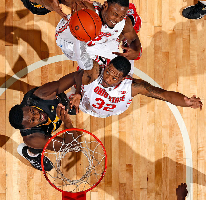 Sports - 2nd place - Ohio State guard Lenzelle Smith Jr. (32) grabs a rebound in front of Iowa guard Anthony Clemmons (5) during the 1st half of their game at Value City Arena in Columbus.  (Kyle Robertson / )