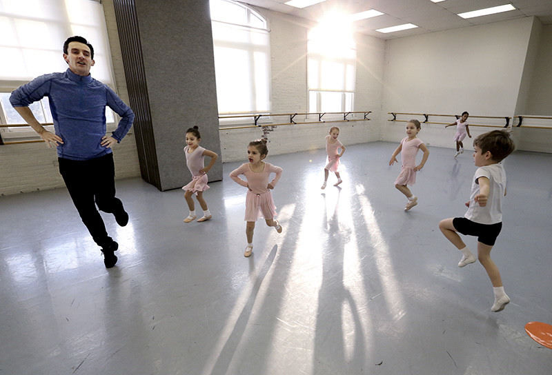 Feature - 1st place - Children follow the lead of Timothy Lynch during a Creative Movement 2 class he teaches at BalletMet in Columbus. The class is for 5 year olds.  The children do simple and fun movements during the 45 minute class which helps develop their coordination. Lynch is the director of BalletMet's academy and was on the move with the children for most of the class.  (Fred Squillante / The Columbus Dispatch)