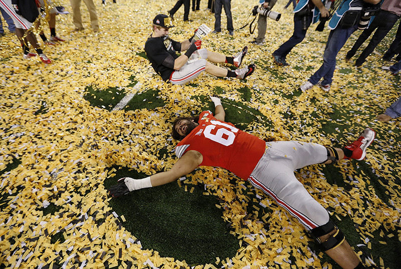 SSports Feature - 1st place - Ohio State offensive lineman Logan Gaskey (61) plays in the confetti following the College Football Playoff National Championship at AT&T Stadium in Arlington, TX. (Jonathan Quilter / The Columbus Dispatch)