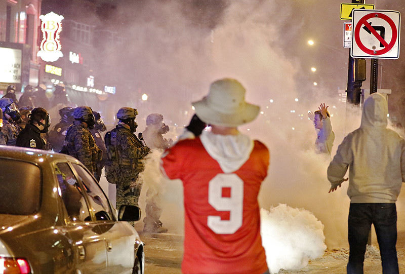 Spot News - 3rd place - Authorities used tear gas and pepper spray to disperse thousands of students and fans on North High Street who were celebrating the Buckeyes' win over Oregon along the Ohio State University campus in Columbus. (Barbara J. Perenic / The Columbus Dispatch)