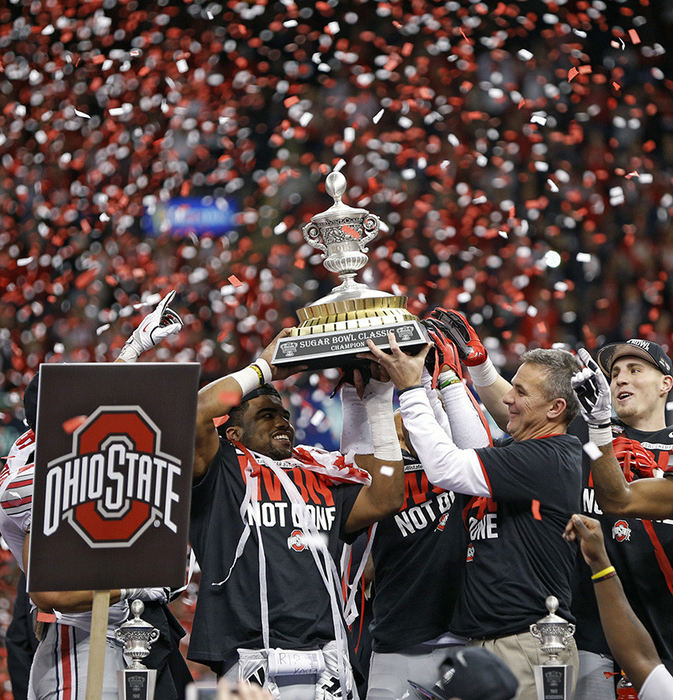 Story - 3rd place - Ohio State running back Ezekiel Elliott (15) and head coach Urban Meyer hold up the Sugar Bowl trophy after beating Alabama in the Allstate Sugar Bowl at the Mercedes-Benz Superdome in New Orleans. (Kyle Robertson / The Columbus Dispatch)