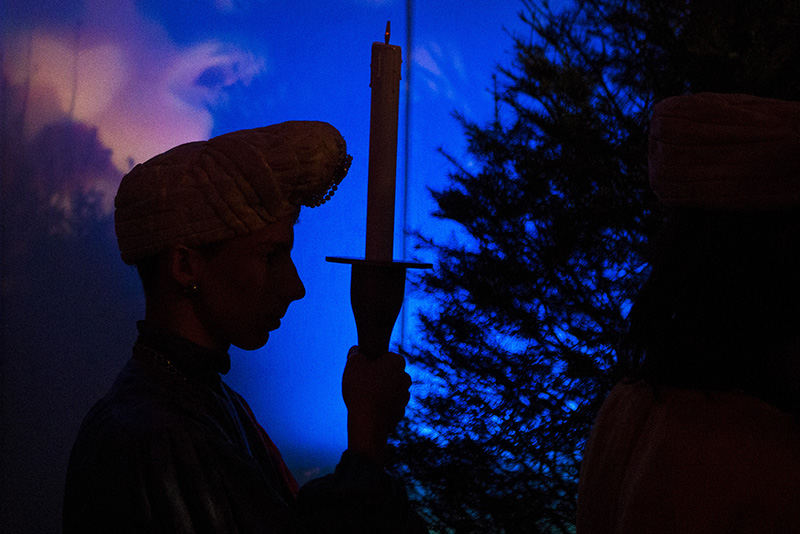 Feature - HM - A torch bearer waits to perform at The Boar's Head and Yule Log Festival presented by Christ Church Cathedral on East Fourth Street in Cincinnati. (Meg Vogel / Cincinnati Enquirer)