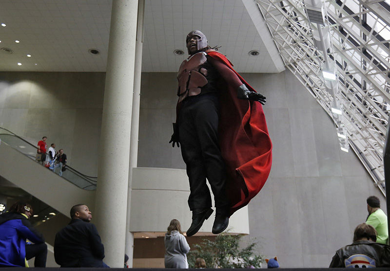 Feature - HM - Mike Rochester was dressed as Magneto this weekend at the Hyatt Regency Columbus / Greater Columbus Convention Center Ohayocon 2016. Rochester is jumping into the air  for photographers (not pictured) because Mike has not mastered how to levitate like Magneto in Marvel Comic's X-Men  (Tom Dodge / The Columbus Dispatch)