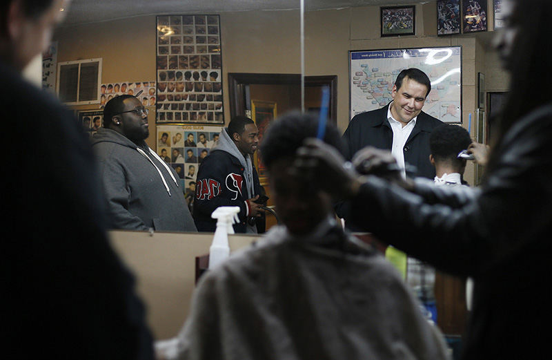 AGeneral News - 2nd place - Mayor Andy Ginther talks to folks getting their hair cut at Dreamers Barber Shop in the South Linden neighborhood of Columbus. The new mayor says he will make it a priority to focus on the blight and problems plaguing that neighborhood.  (Adam Cairns / The Columbus Dispatch)