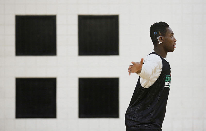 SSports Feature - 1st place - Dublin Coffman senior Jason Boateng practices in the school's auxiliary gym. Boateng, who is deaf, relies on a cochlear implant to help him hear, although the crowd noise at games can render the implant useless at times. (Adam Cairns / The Columbus Dispatch)