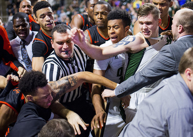 05Sports Feature - HM - An altercation breaks out involving Ohio University forward Treg Setty (right with tattoo) and Bowling Green  guard JD Tisdale (bottom left with tattoo) at the BGSU bench during the second half of play at the Convocation Center in Athens. Tisdale and Setty received technical fouls along with two other Bobcats. (Isaac Hale / Ohio University)