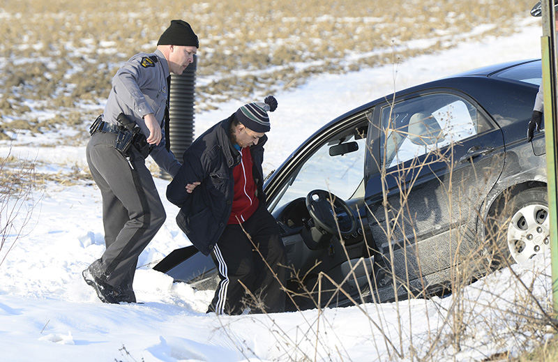 Spot News - 3rd place - Ismael Gonzalez, of Findlay is arrested on a felony warrant after leading police on a high speed chase across three counties, ending with parts flying off the car and a crash into a ditch at the corner of County Roads 153 and 106 in Lindsey. (Molly Corfman / The (Fremont) News-Messenger)