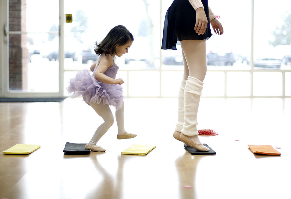 Feature - 2nd place - Catarina Carrau, 3, tries to follow her mother, Silvia, during a Mom and Me ballerina class taught by Tina Ferreira at Training Grounds in Dublin.  Catarina has a speech delay and both Sivia and Tina work with Catarina while practicing her ballerina skills. (Kyle Robertson / The Columbus Dispatch)