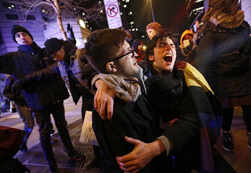 ASpot News - 3rd place - Connor Lefevers, 17, of Columbus, at right, screams in pain after being pepper sprayed by Columbus Police as protestors block traffic on High Street just south of the Ohio Statehouse in Columbus. The protest started peacefully at the Statehouse, but police stepped in when protestors moved onto High Street and began to block traffic.  (Adam Cairns / The Columbus Dispatch)