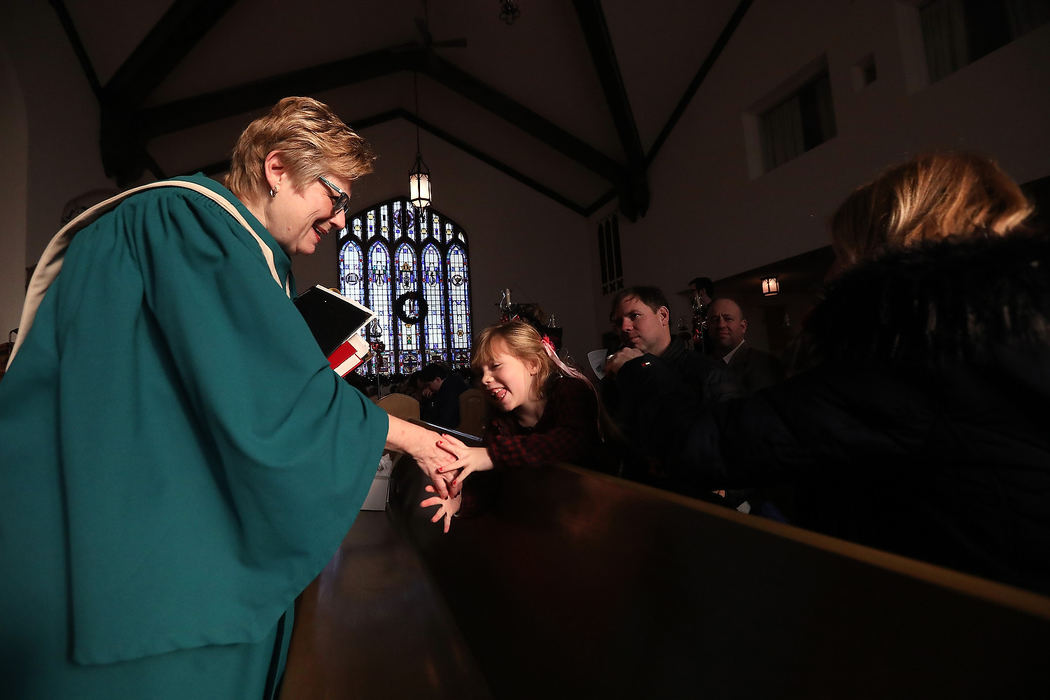 Feature - 1st placeCindy Sauppe (left) smiles at her granddaughter Audrey Korczynski, during the last service at Bethany Lutheran Church. (Amy E. Voigt/The Blade)