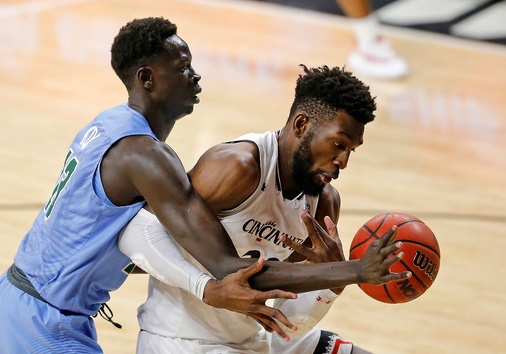 Sports - 3rd placeCincinnati Bearcats forward Eliel Nsoseme (right) and Tulane center Buay Koka (13) struggle for a rebound in the first half of game at Fifth Third Arena in Cincinnati. (Sam Greene/The Cincinnati Enquirer)