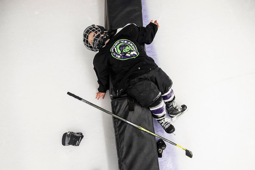 Sports Feature - 1st placeRyze Owens lays on a bumper while taking a break during  a practice scrimmage against the Sylvania Maple Leafs at the Slater Family Ice Arena in Bowling Green. The Black Swamp Ice Frogs is a hockey team that is part of a league for kids with special needs. (Rebecca Benson/The Blade)