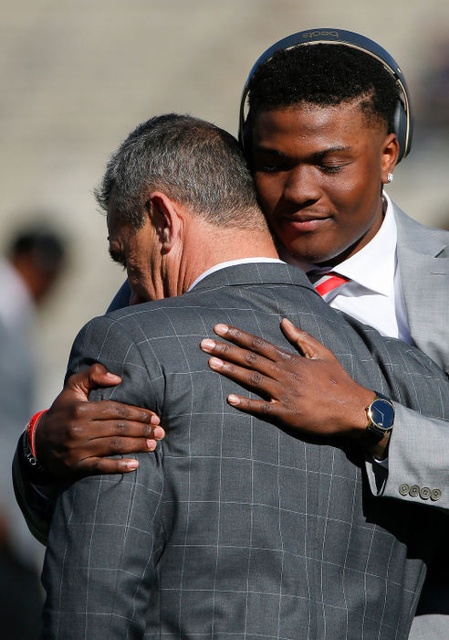 Sports Feature - 2nd placeOhio State quarterback Dwayne Haskins Jr. hugs head coach Urban Meyer before heading to the locker room after arriving for the 105th Rose Bowl game between Ohio State and the Washington Huskies. Urban Meyer retired as head coach following the game. (Joshua A. Bickel/The Columbus Dispatch)