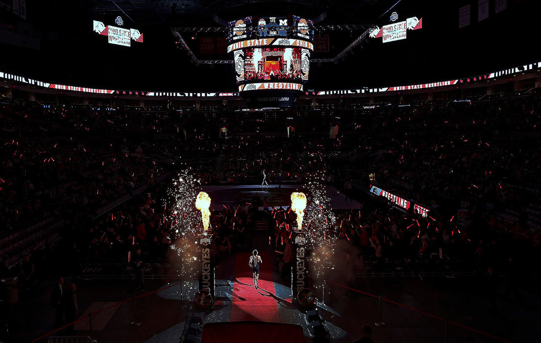 Sports Feature - 3rd placeOhio State's Malik Heinselman enters the arena to take on Michigan's Drew Mattin during a 125 match  at Value City Arena in Columbus. Mattin won a 12-6 decision over Heinselman.  (Kyle Robertson/The Columbus Dispatch)