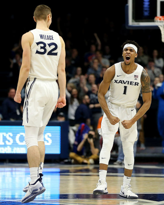 Sports Feature - HMXavier Musketeers guard Paul Scruggs (1) celebrates with forward Ryan Welage (32) after scoring a 3-point basket in the second half against Seton Hall at the Cintas Center in Cincinnati. Seton Hall won 80-70.  (Kareem Elgazzar/The Cincinnati Enquirer)