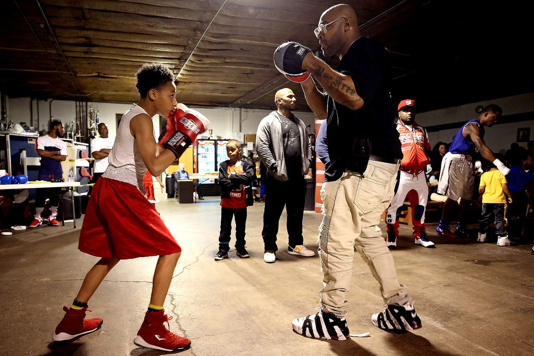 Story - 2nd placeMason Huntley, 13, prepares with his dad and coach Letelle Huntley before his bout during "The Toledo Throwdown" boxing competition hosted at the Japan Karate Academy in Toledo. (Kurt Steiss/The Blade)