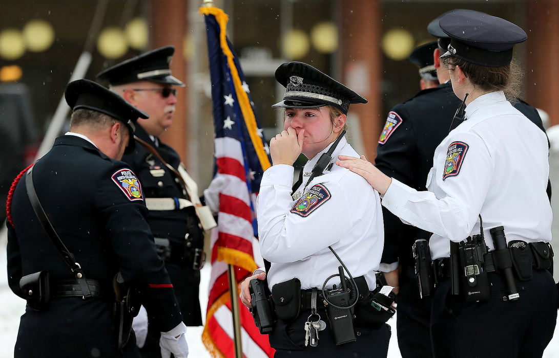 General News - 1st placeMembers of the North College Hill Police Department embrace following the procession for Colerain Township Police Officer Dale Woods. Woods served in the North College Hill Police Department before Colerain. Woods, 46, died after being hit by a pickup truck while working at the scene of a crash. (Kareem Elgazzar/The Cincinnati Enquirer)