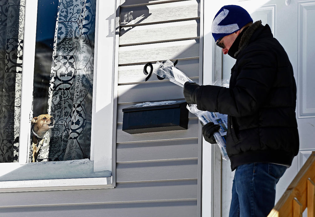 General News - 2nd placeVolunteer Benny Friedman of Cincinnati attracts attention as he leaves a resource bag at an Oakwood Ave. home. Friedman was taking part in a  service event to celebrate Dr. Martin Luther King Jr's vision. (Fred Squillante/The Columbus Dispatch)