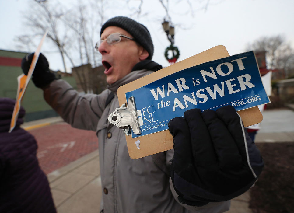 General News - 2nd place - Lee Brooker of Kent protests the the rising tensions between the United States and Iran on the corner of Franklin and Main streets in Kent. (Jeff Lange/Akron Beacon Journal)