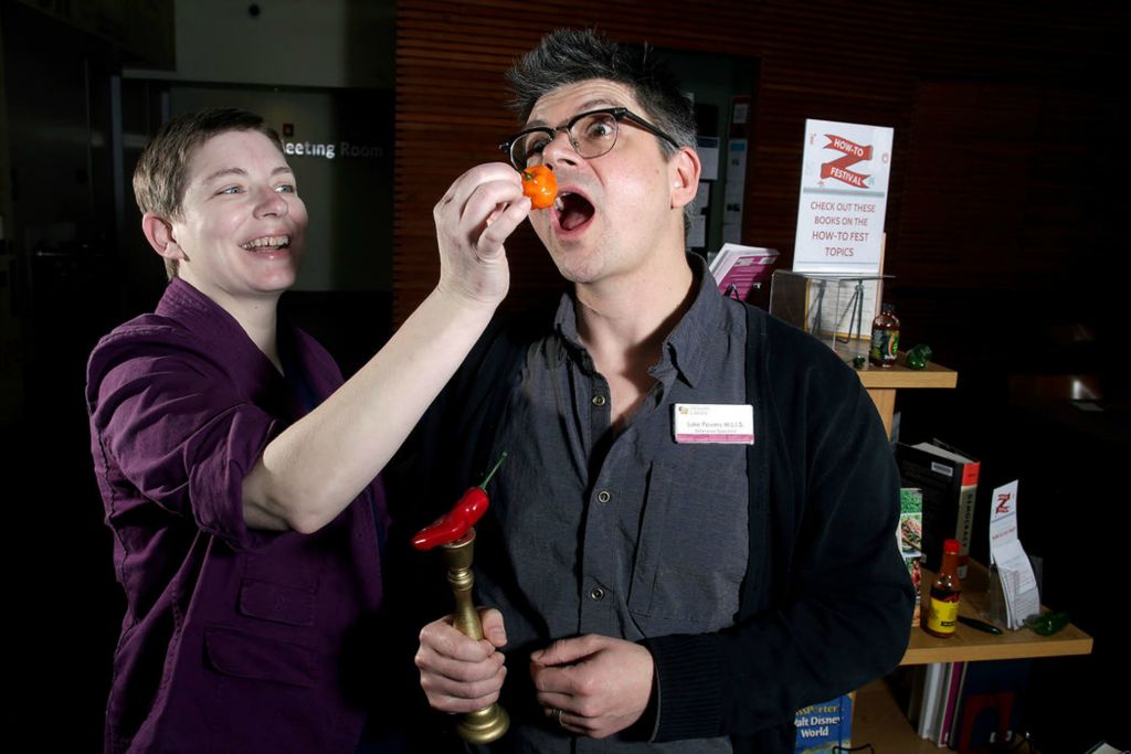 Portrait - 1st place - Mandy Henning, Powell branch manager, and Luke Powers, Orange Branch adult services specialist, will be teaching guests how to survive eating spicy food during one of the eight, short seminars for the Delaware County District Library Orange Branch's "How-To Festival" in Lewis Center. Each seminar will show attendees how to do different things. (Shane Flanigan/ThisWeek Community News)