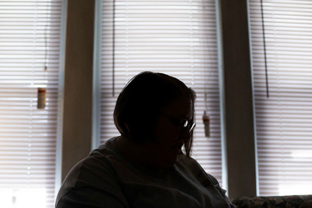 Portrait - 2nd place - A woman sits in her living room in her apartment in Toledo. She is one of four unnamed victims in a federal lawsuit filed by the U.S. Department of Justice against Toledo landlord Anthony Hubbard. The suit alleges Mr. Hubbard violated the Fair Housing Act by sexually harassing several female tenants.  (Rebecca Benson/The Blade)