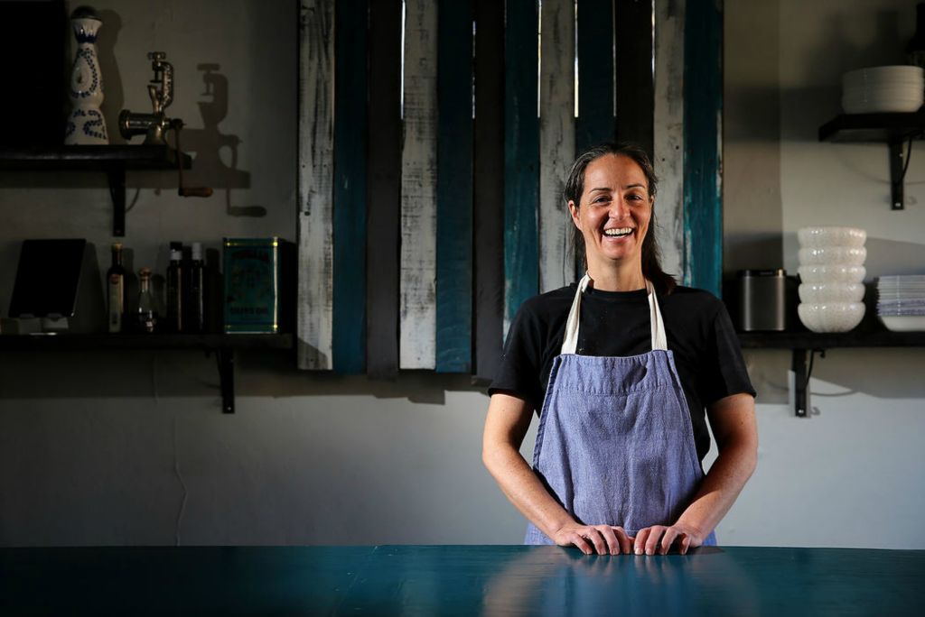 Portrait - 3rd place - Chrissy Antenucci stands for a portrait in the dining room, where she hosts pop-up dinners at The Wheel in Cincinnati's Oakley neighborhood.  (Kareem Elgazzar/The Cincinnati Enquirer)