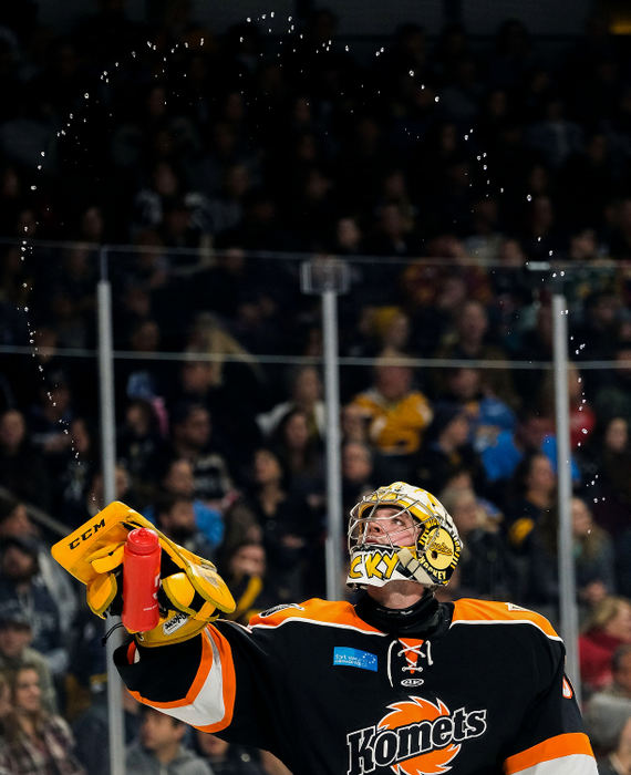 Sports Feature - HM - Fort Wayne goalie Patrick Munson sprays water from his bottle after getting a drink at a timeout during an ECHL hockey game against the Toledo Walleye at the Huntington Center in Toledo. (Kurt Steiss/The Blade)